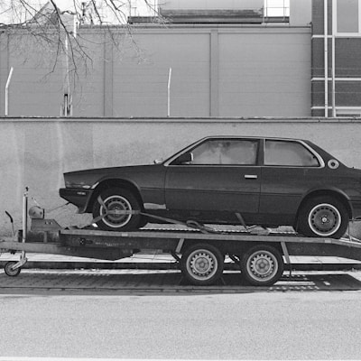 a car is being towed on a flatbed trailer