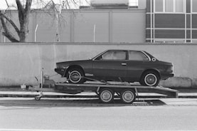 a car is being towed on a flatbed trailer
