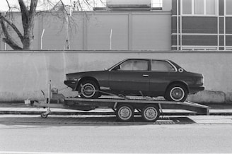 a car is being towed on a flatbed trailer