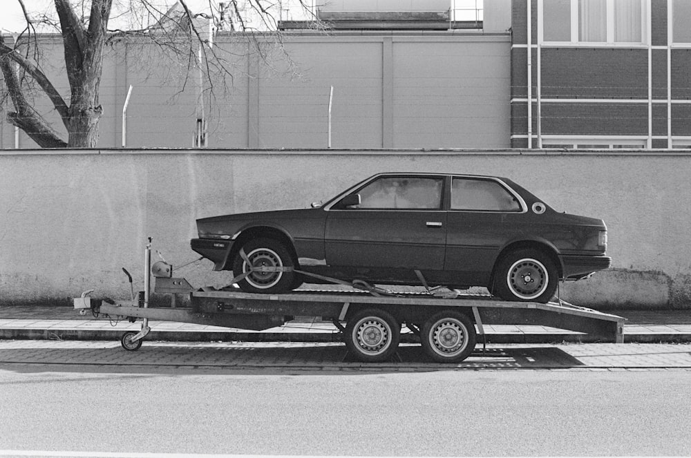 a car is being towed on a flatbed trailer