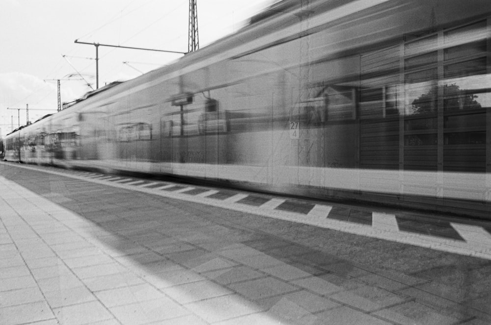 a black and white photo of a train passing by