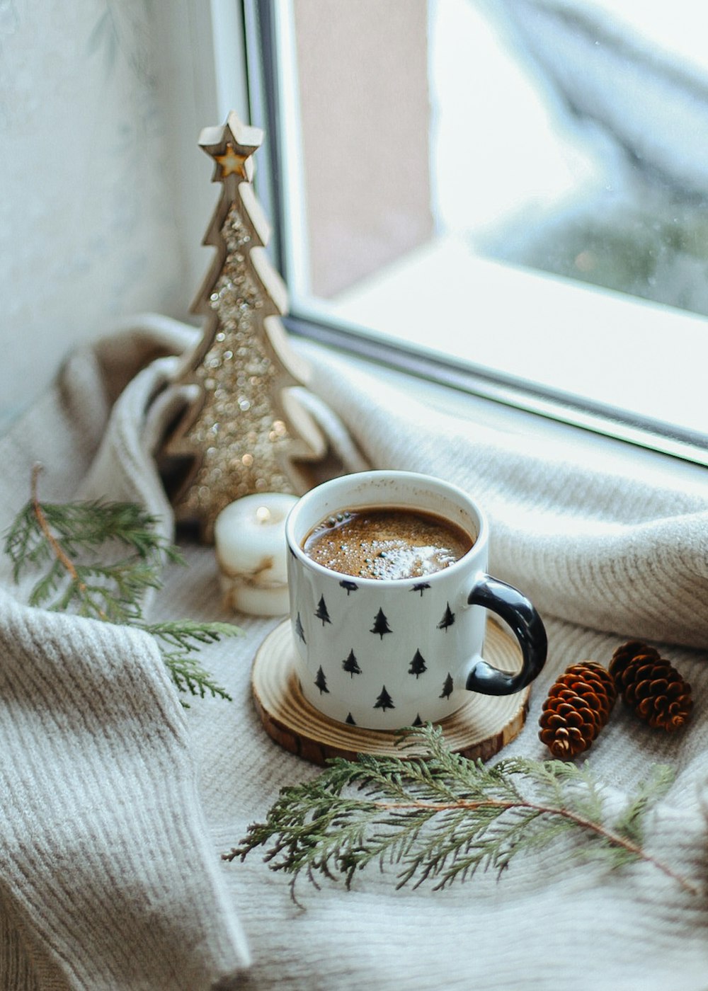 a cup of coffee sitting on top of a wooden plate