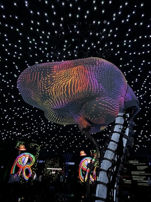 Close-up of a floating sculpture illuminated by soft cosmic light in the VR gallery.