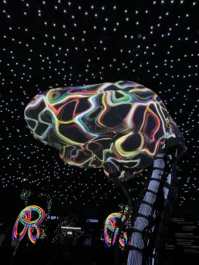 An abstract digital brain composed of glowing neural network nodes connecting in vibrant blue and purple hues.