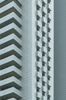 a tall white building next to a tall white building