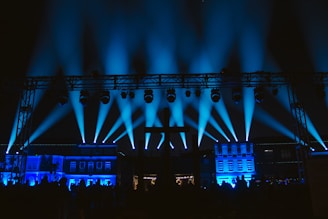 a stage lit up with blue lights at night