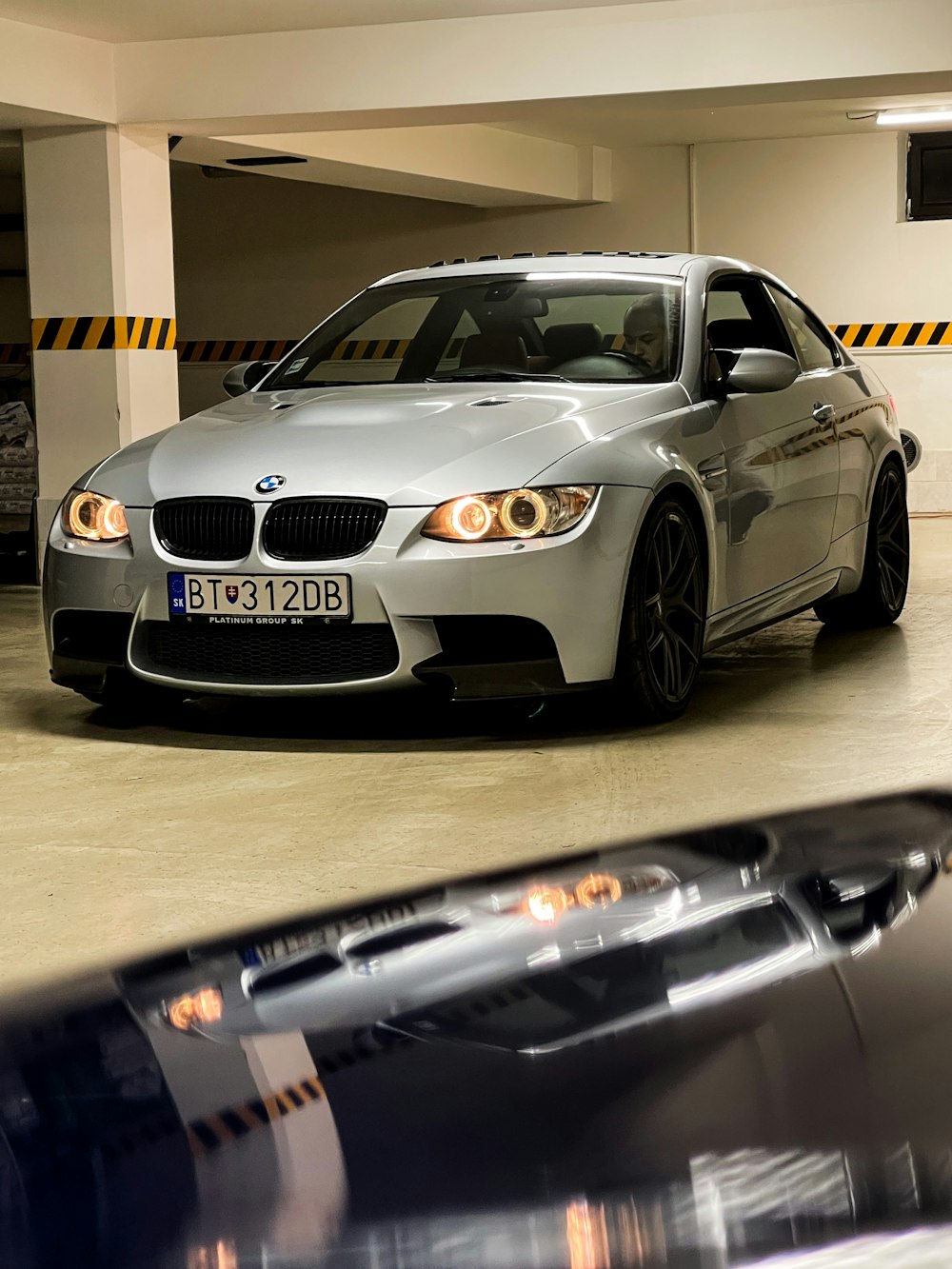 a silver car parked in a parking garage