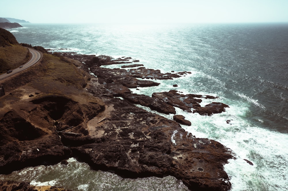 an aerial view of a road near the ocean