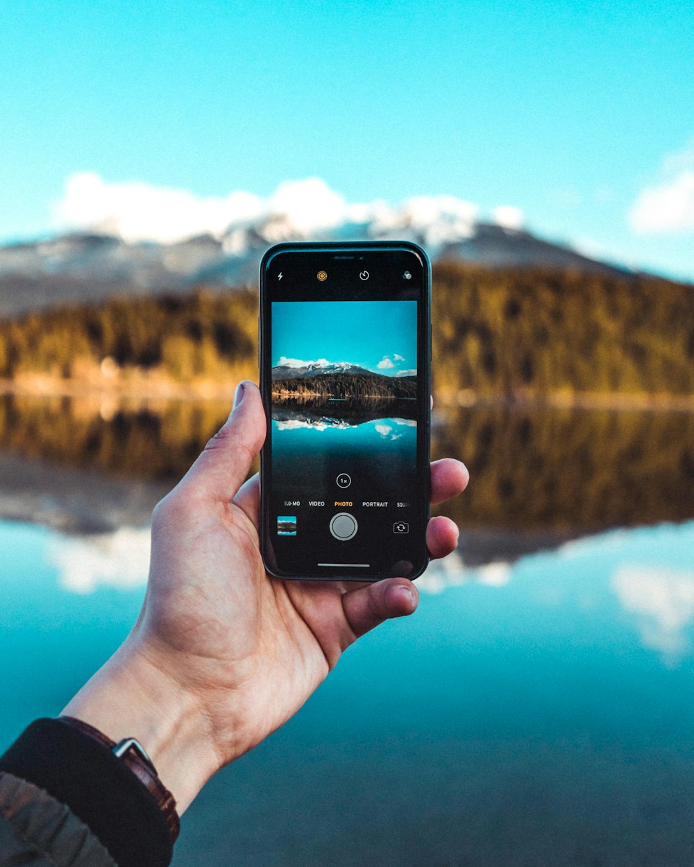 a person holding a cell phone in their hand