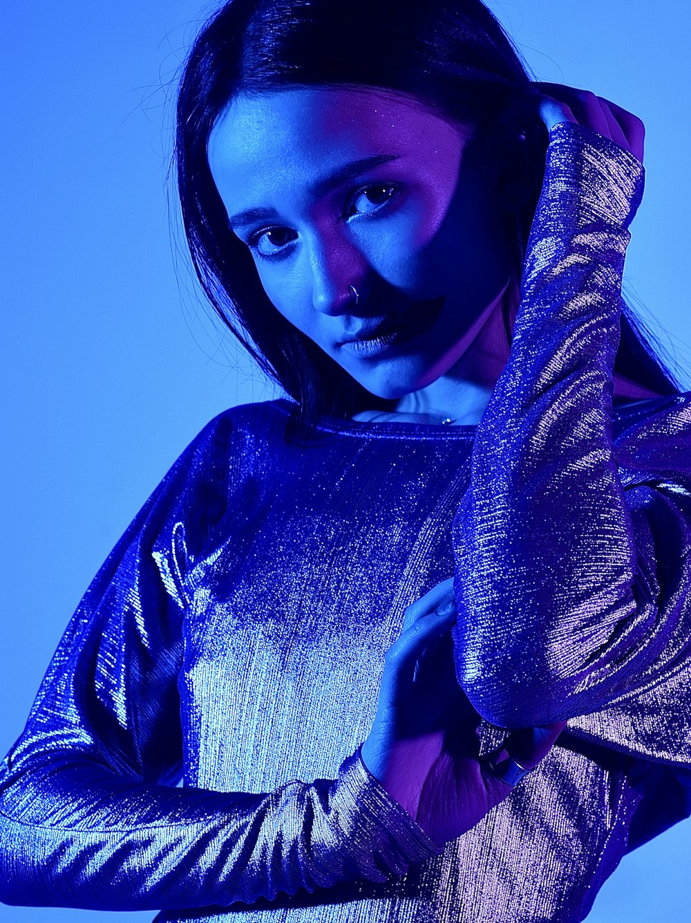 a woman in a metallic dress posing for a picture