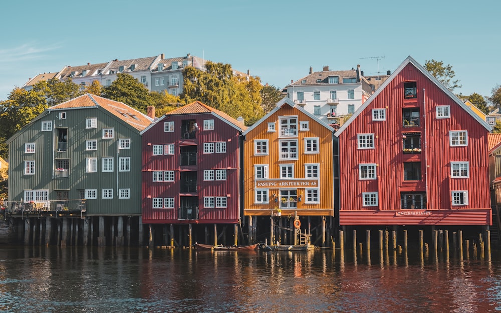 a row of houses sitting on top of a lake