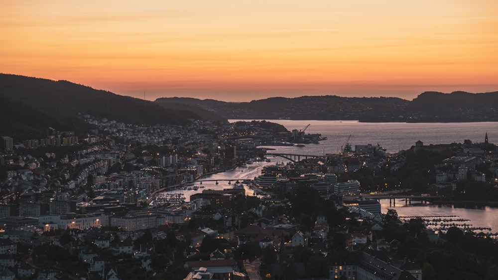 a view of a city and a body of water at sunset