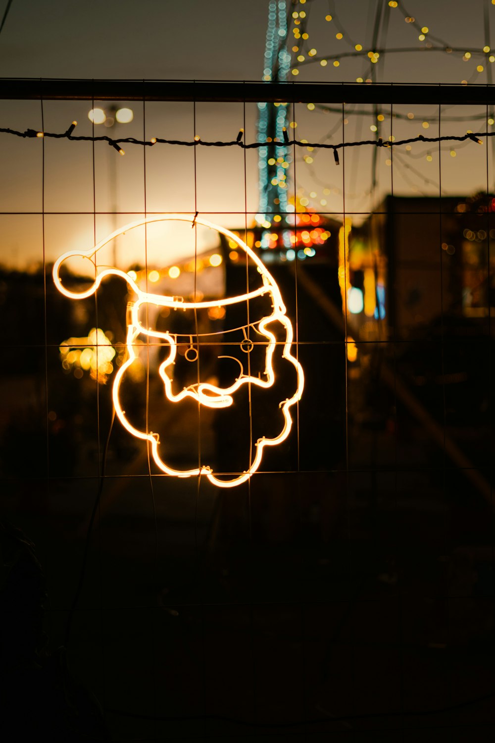 a picture of a santa clause on a fence