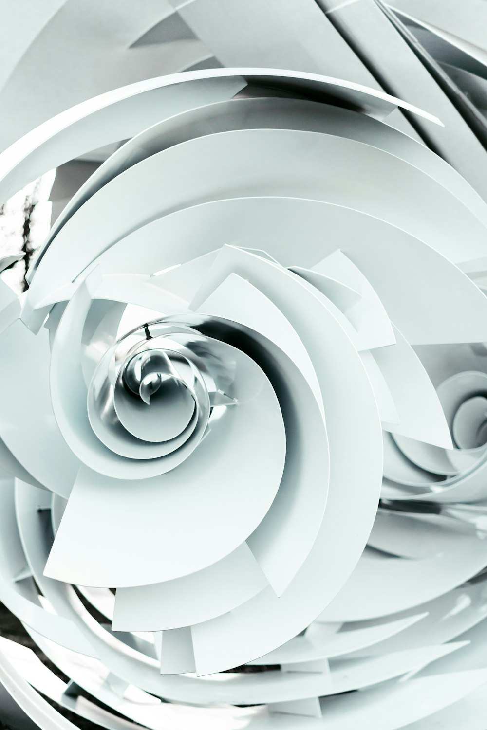 an abstract white background with a spiral design
