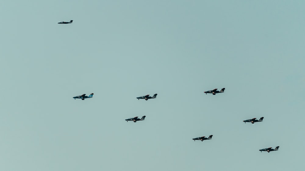 a group of planes flying in formation in the sky