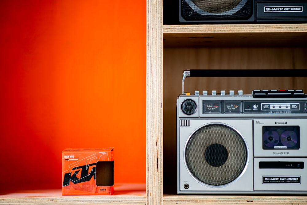a boombox sitting on top of a wooden shelf