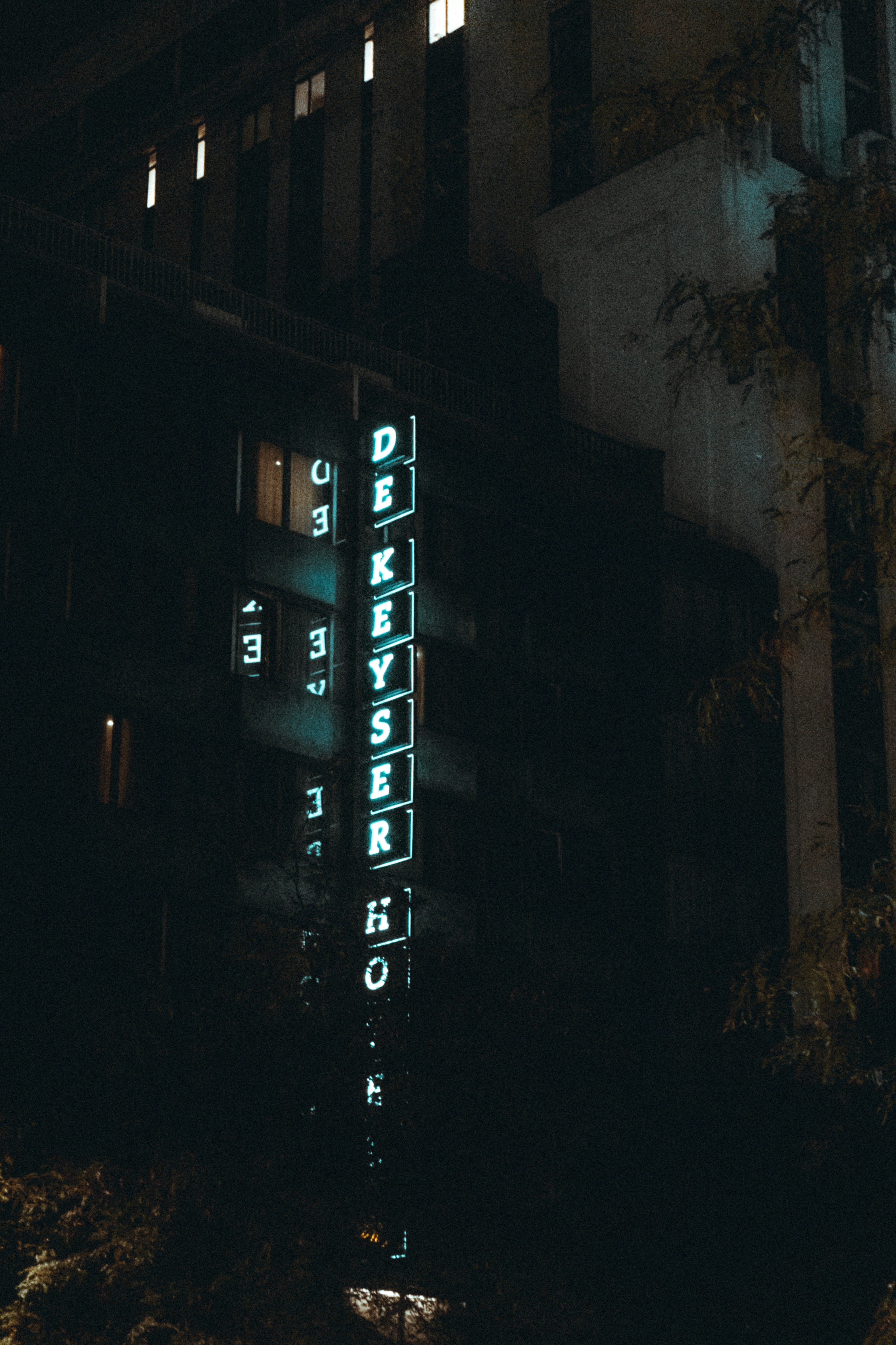 a tall building with a lit up sign on it's side