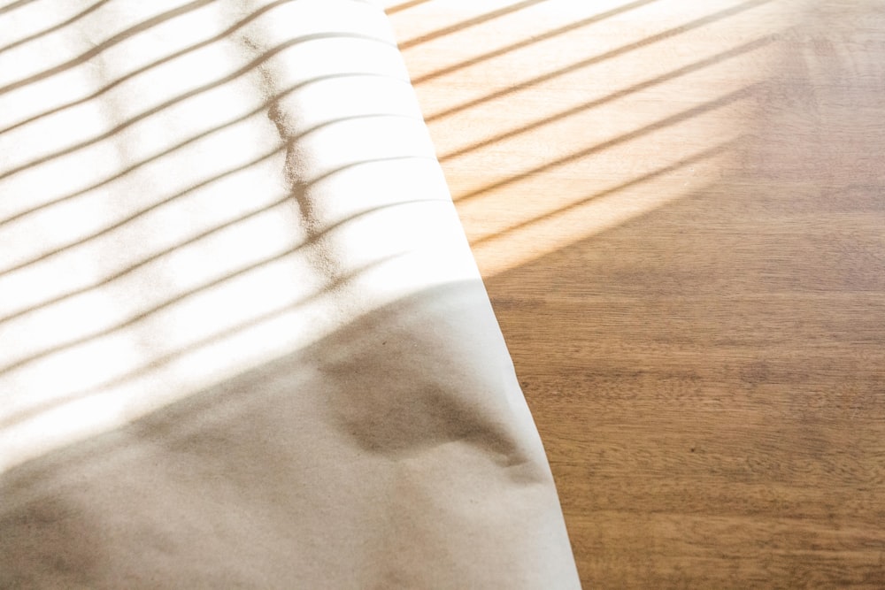 a wooden table with a white sheet on it