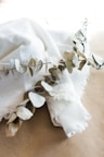 a white cloth with some leaves on it