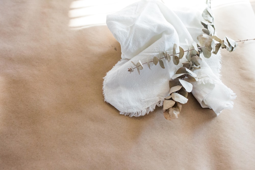 a piece of cloth and some leaves on a table