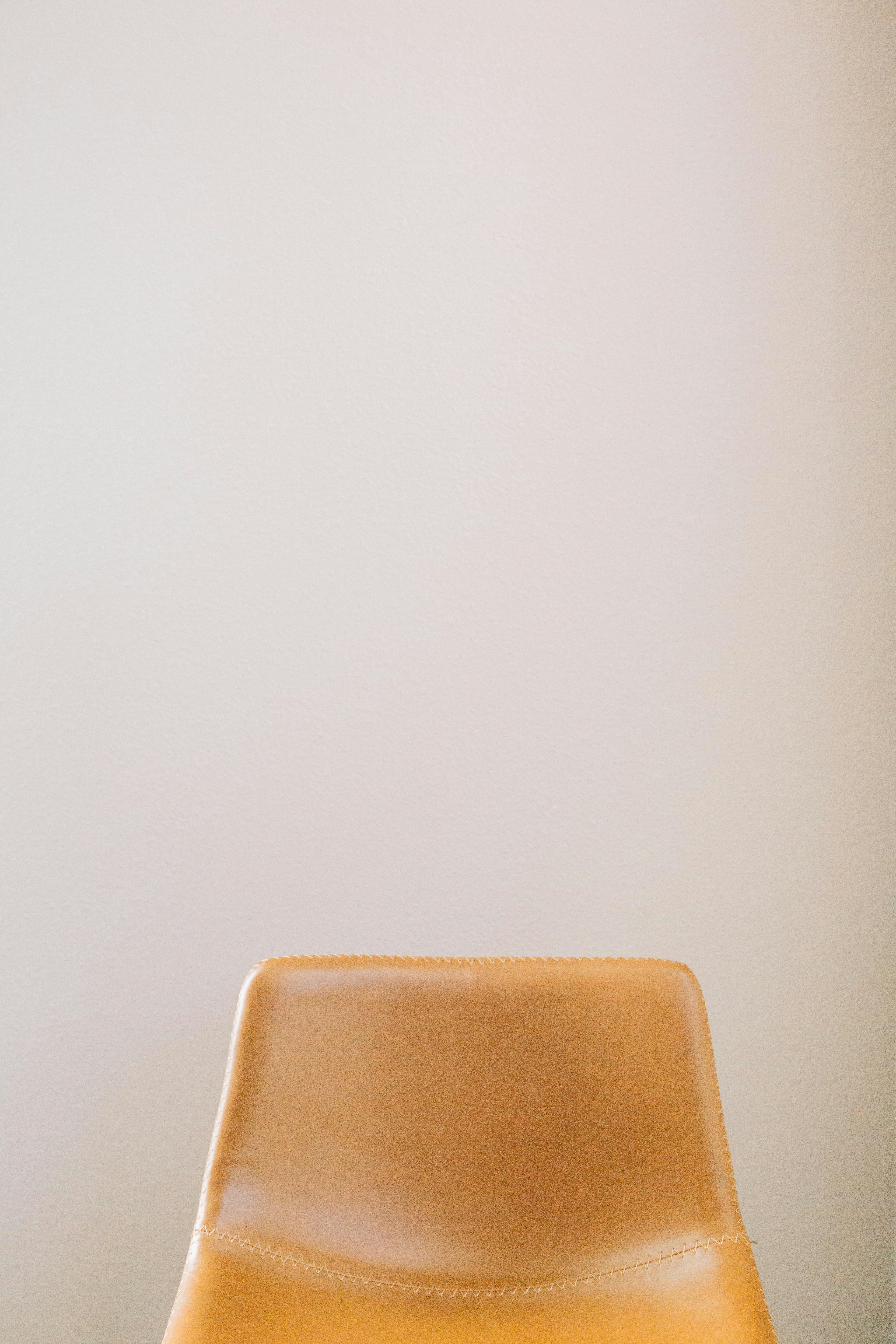 a brown chair sitting on top of a hard wood floor
