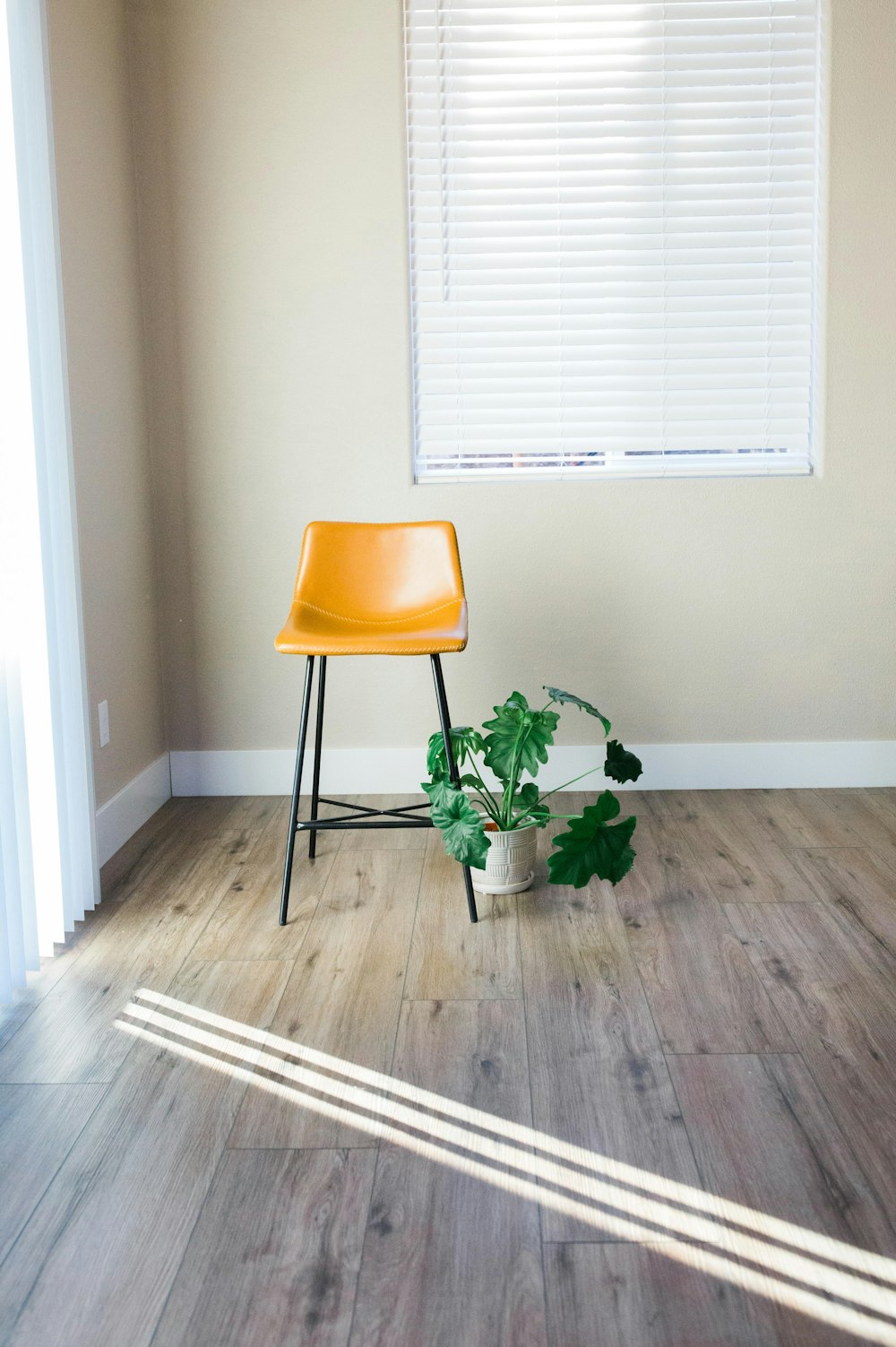 a yellow chair sitting in a room next to a window