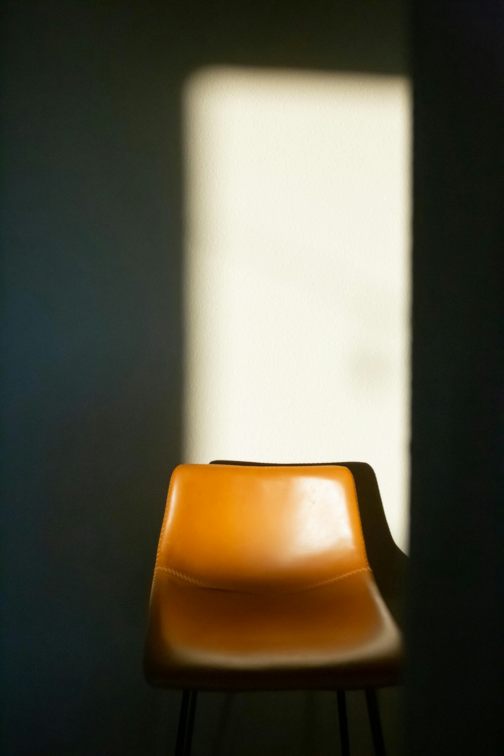 a brown chair sitting in front of a window