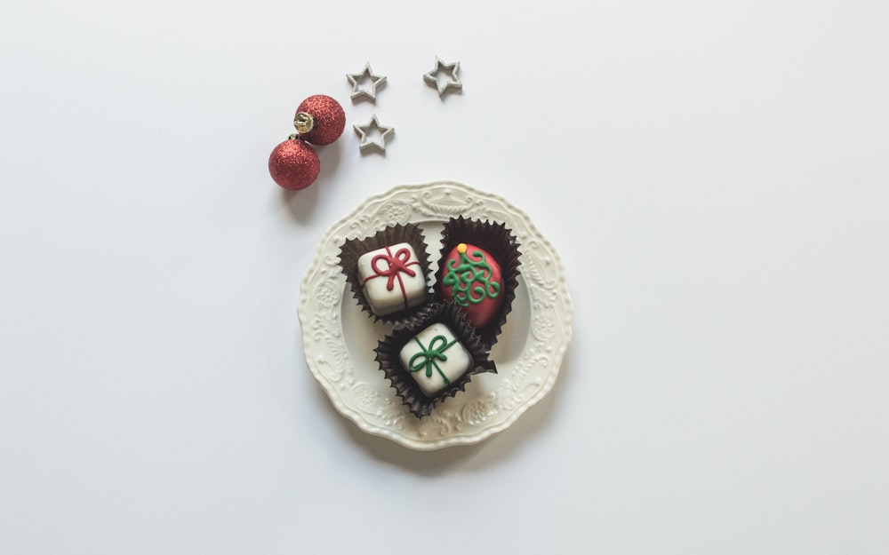 a white plate topped with two heart shaped chocolates