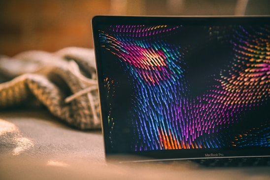 a laptop computer sitting on top of a bed