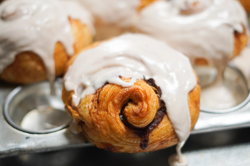 a close up of a pastry with icing on a tray