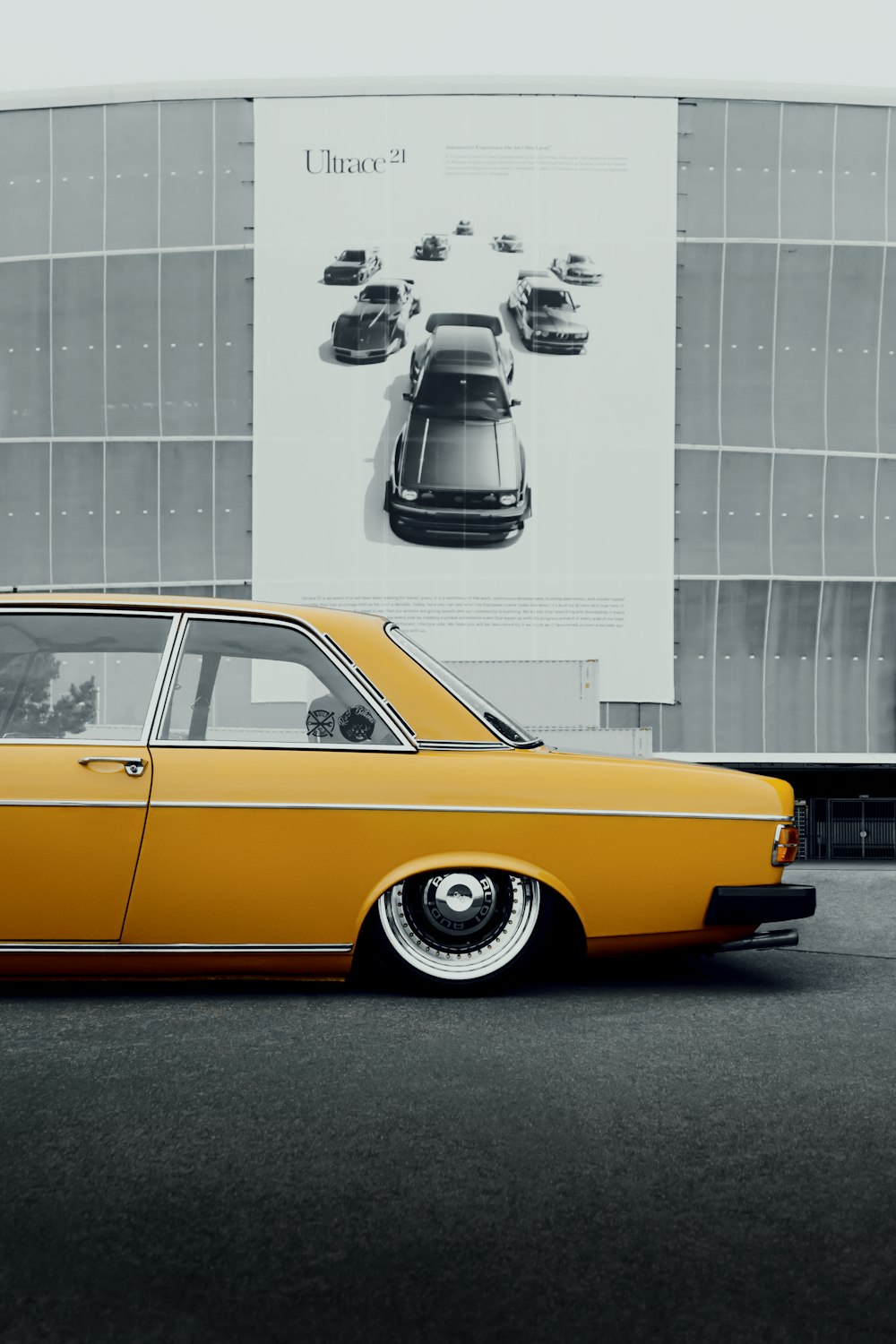 a yellow car parked in front of a building