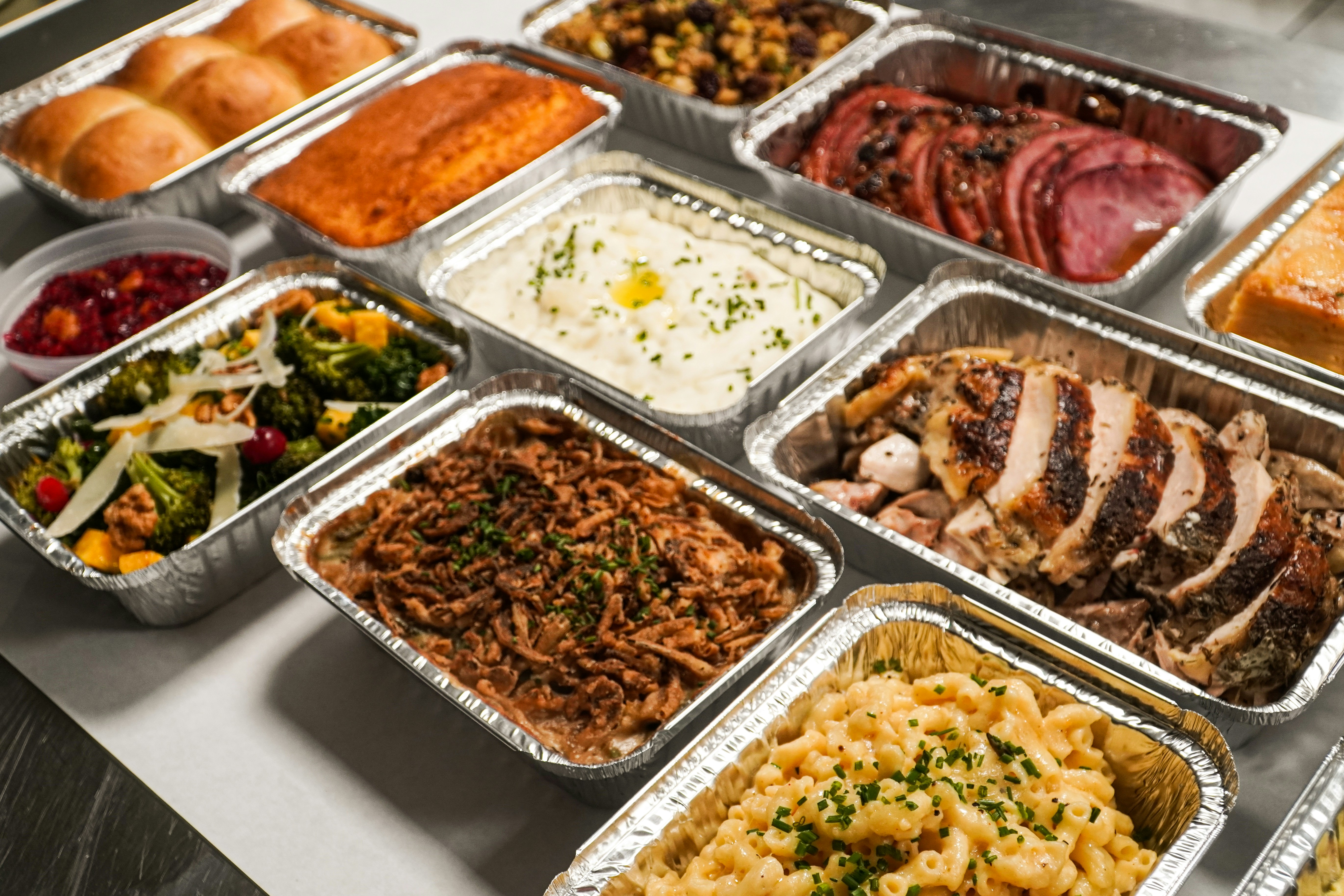 a table topped with lots of trays of food