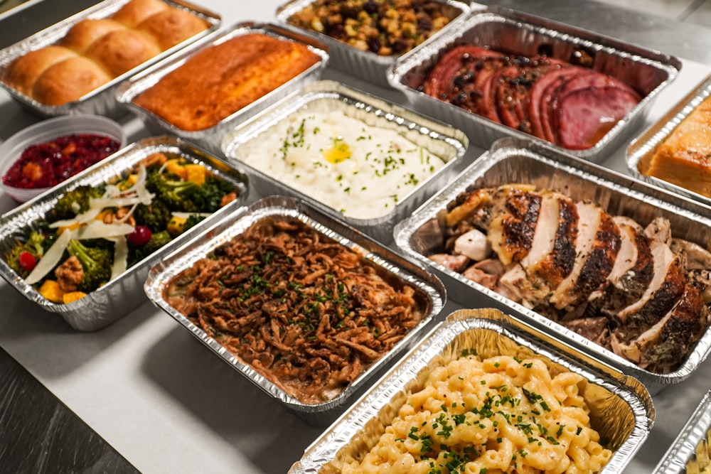 a table topped with lots of trays of food