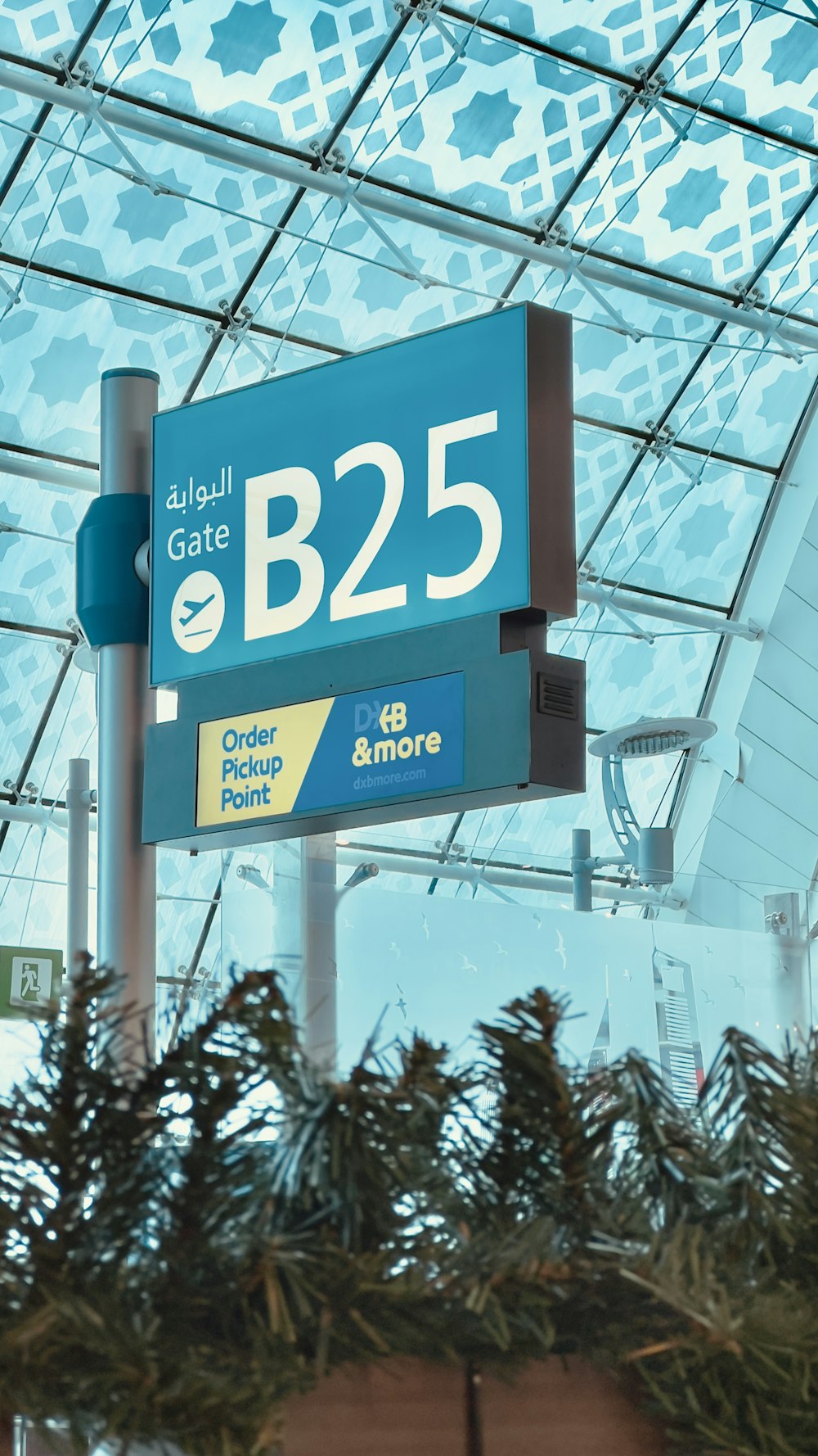 a blue and white sign under a glass roof