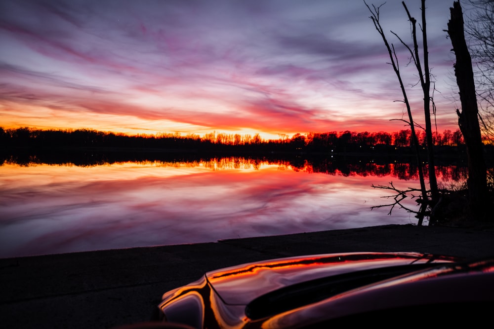 a car parked next to a body of water