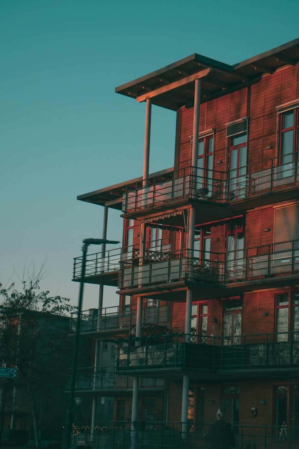 a tall red building with balconies and balconies