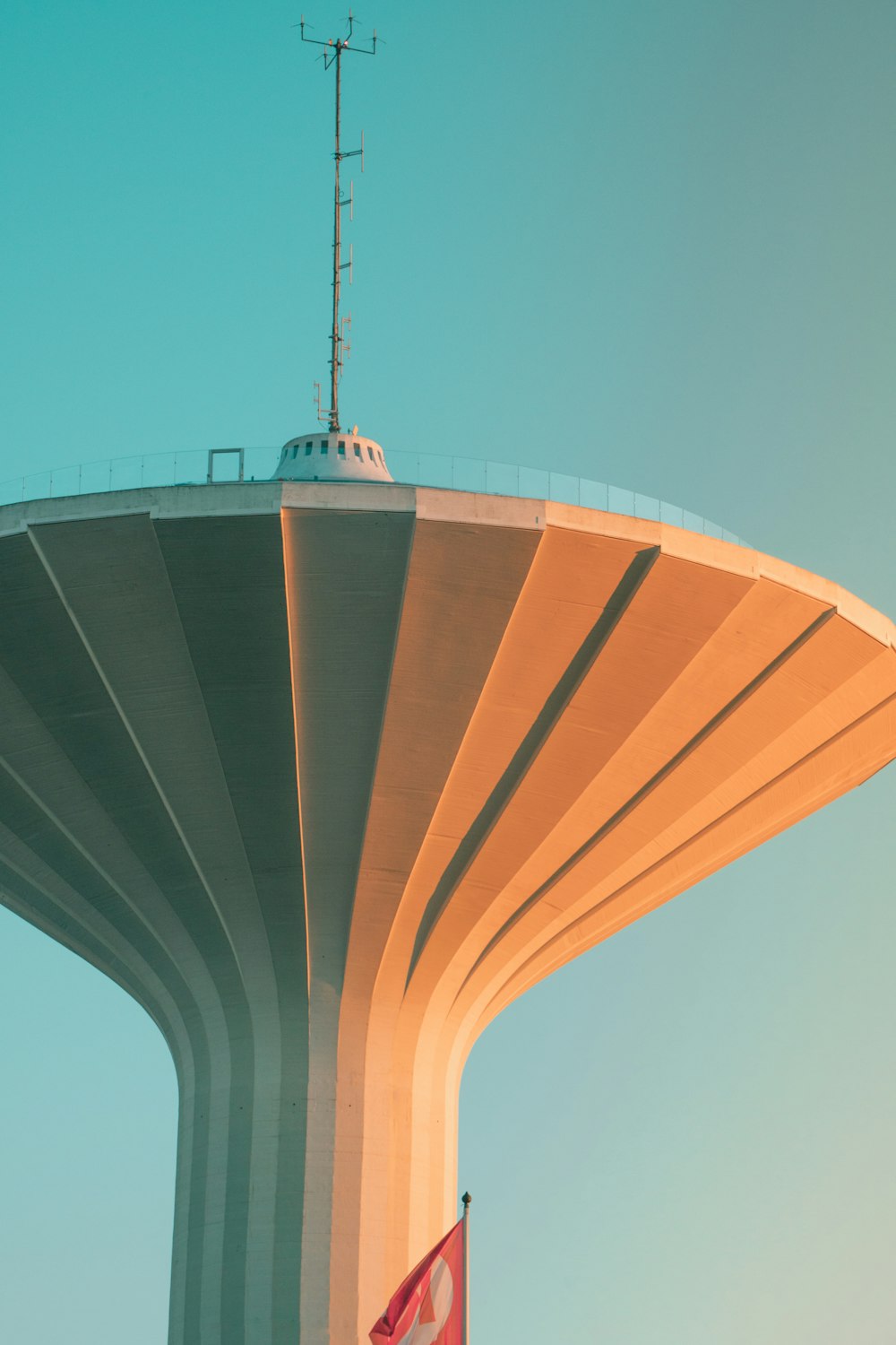 a tall tower with a flag on top of it