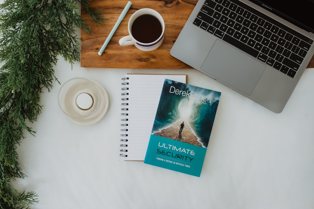 a book sitting on top of a desk next to a laptop