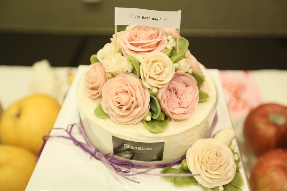 a white cake with pink flowers on top of it