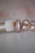 a close up of a tassel with pearls