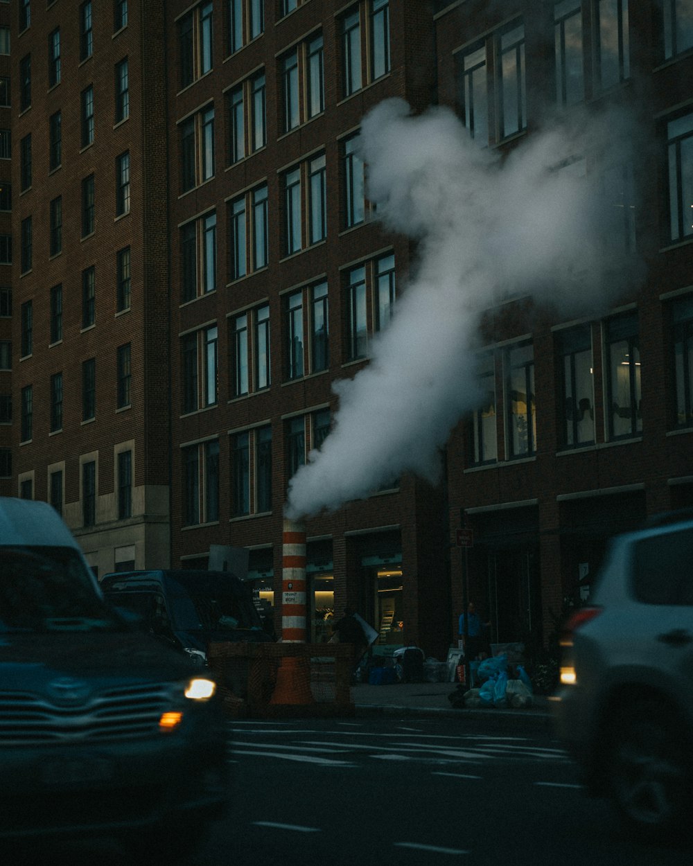 a smokestack coming out of a pipe on a city street