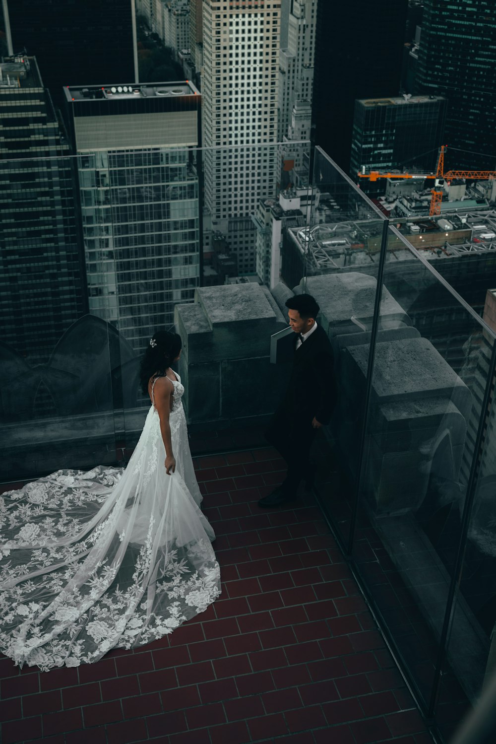a bride and groom standing on top of a building