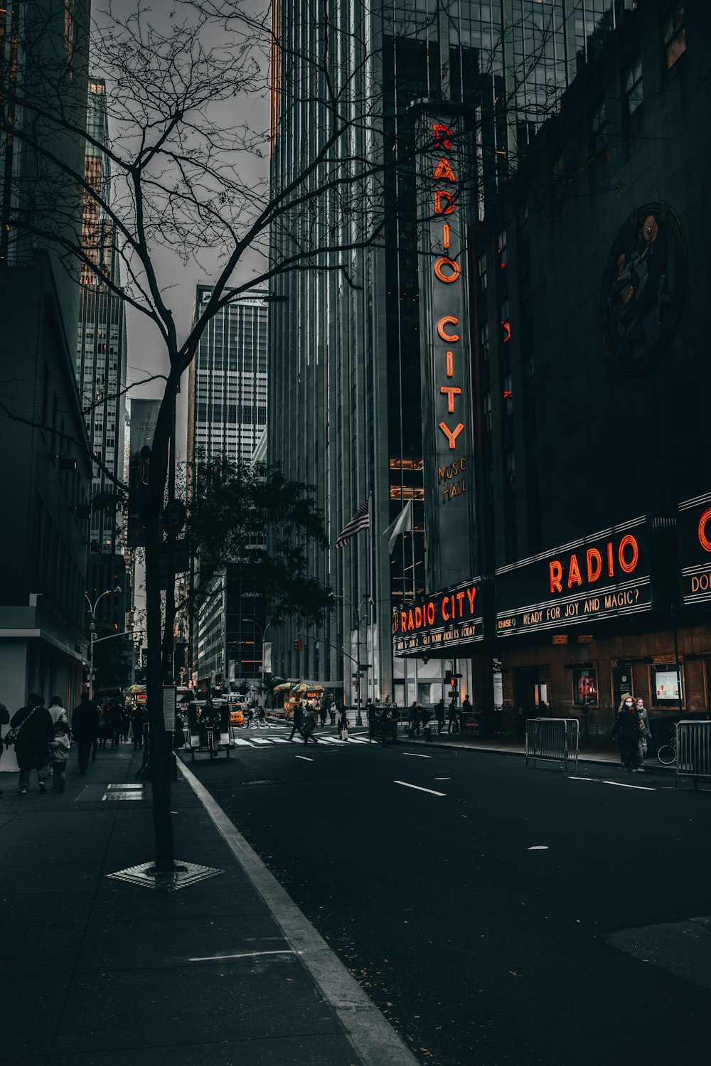 a city street at night with a radio city sign