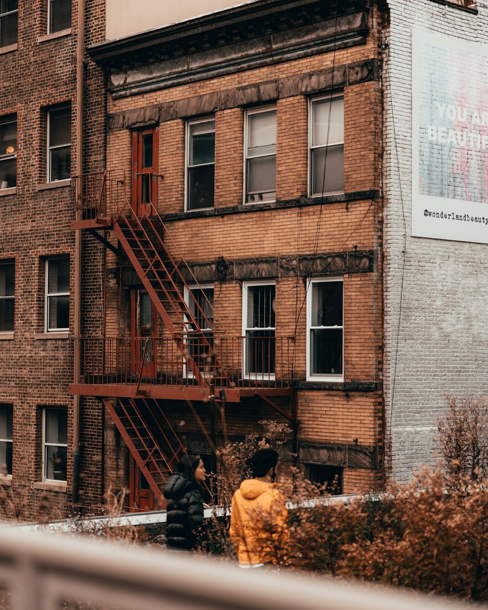 a fire hydrant in front of a tall brick building