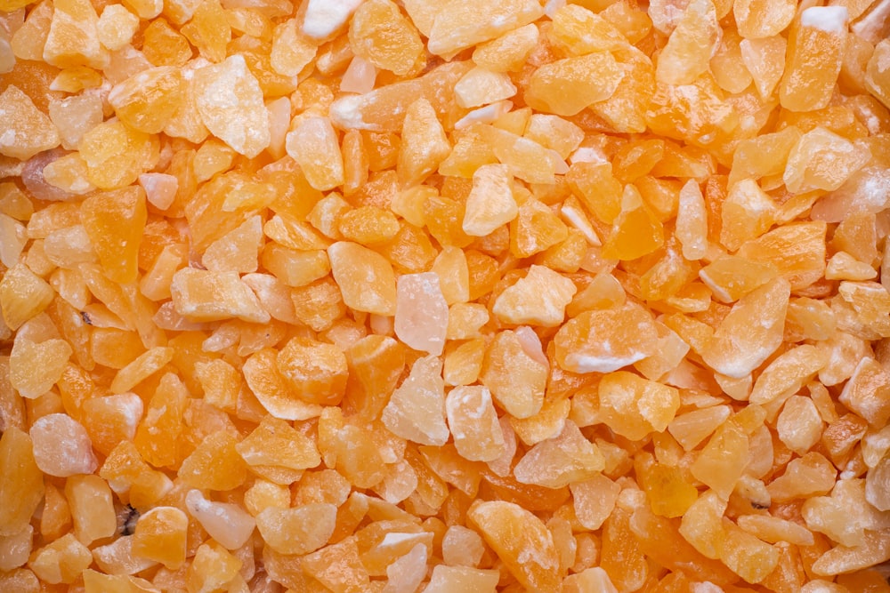 a close up of a pile of orange colored rocks