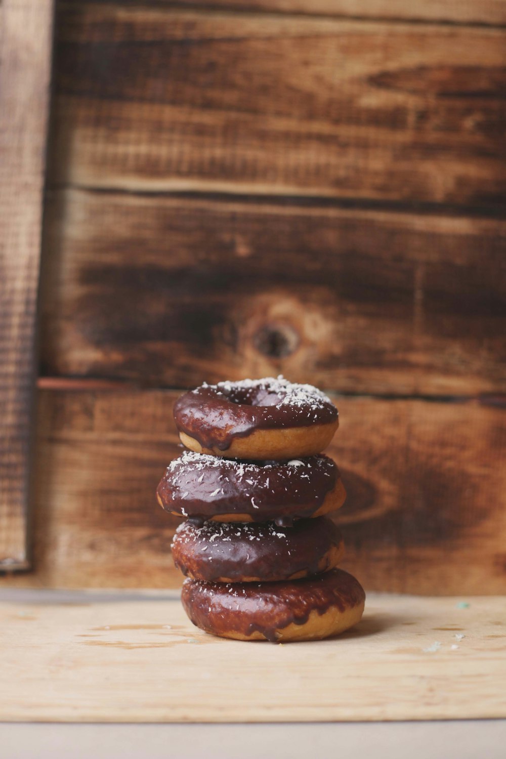 a stack of doughnuts sitting on top of a wooden table
