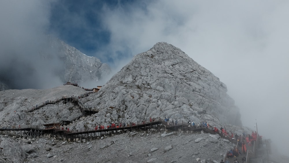 a group of people standing on top of a mountain