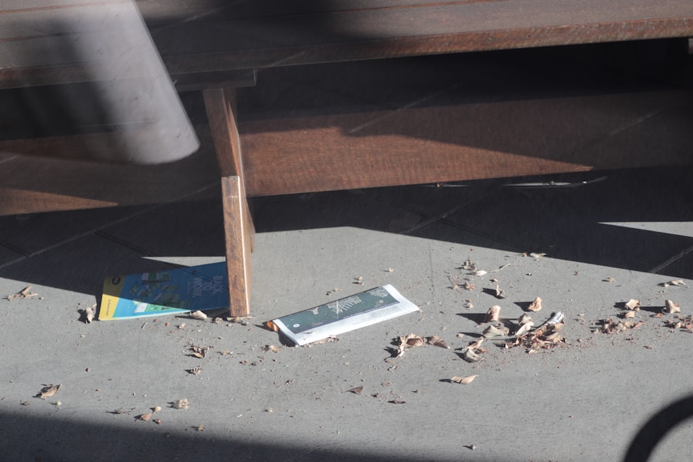 a broken book laying on the ground next to a wooden pole