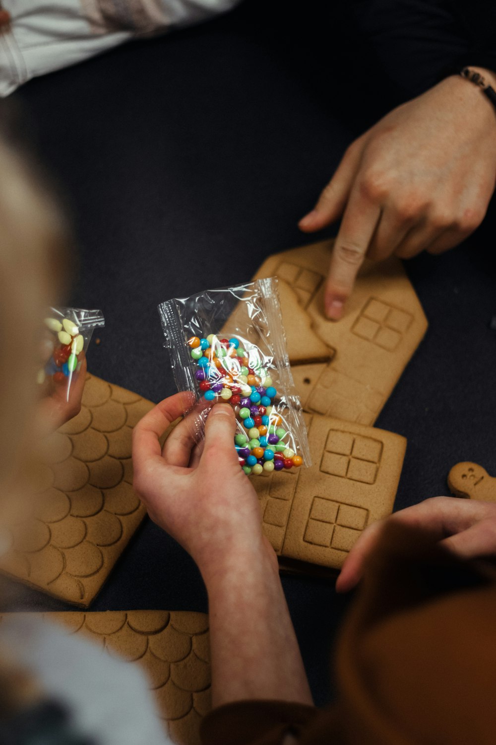 a group of people sitting around a table with a bag of candy