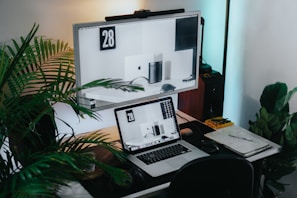 a laptop computer sitting on top of a wooden desk